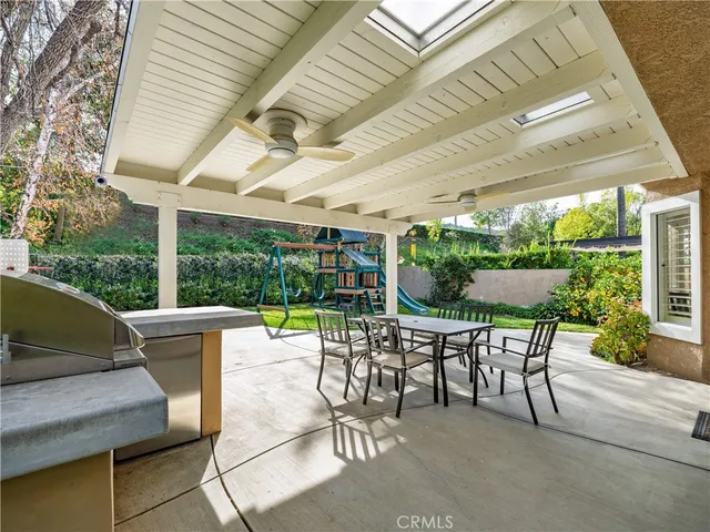 a view of a patio with a table chairs and a backyard
