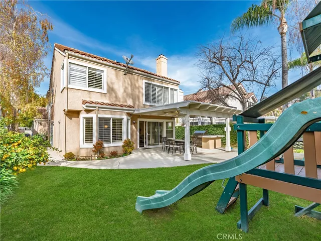 a front view of a house with a yard table and chairs