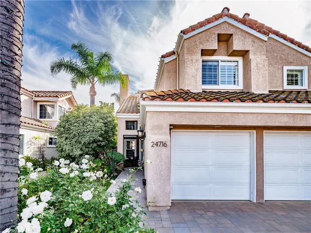 a front view of a house with a yard garage and outdoor seating