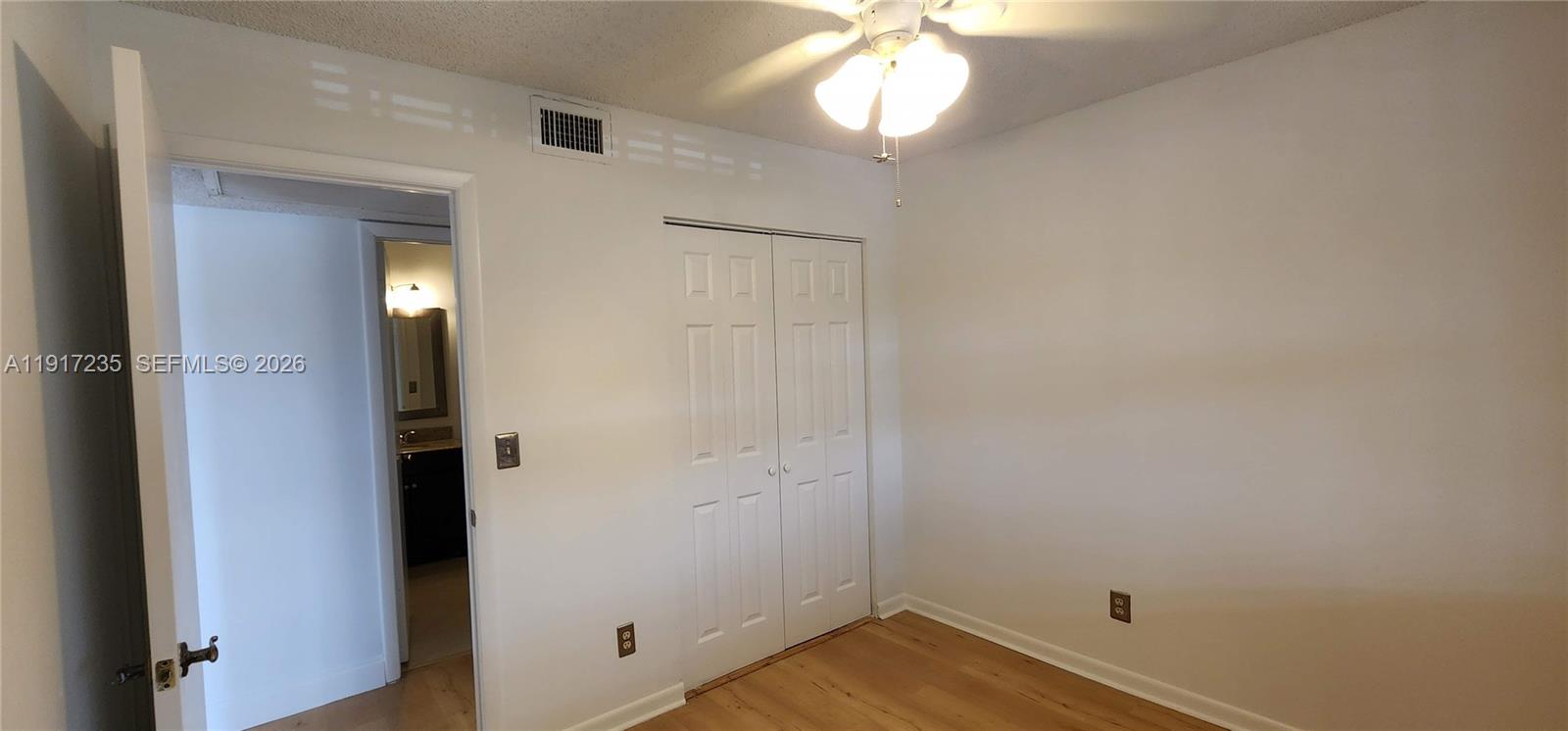 10029 Winding Lake Road, Unit 201 Sunrise, FL 33351 - Photo 11 of 22 an empty room with wooden floor