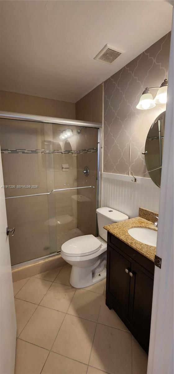 10029 Winding Lake Road, Unit 201 Sunrise, FL 33351 - Photo 17 of 22 a bathroom with a granite countertop sink toilet and shower