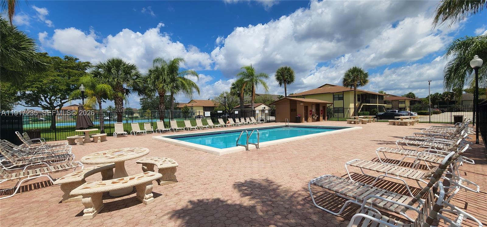 10029 Winding Lake Road, Unit 201 Sunrise, FL 33351 - Photo 21 of 22 an outdoor space with pool and furniture
