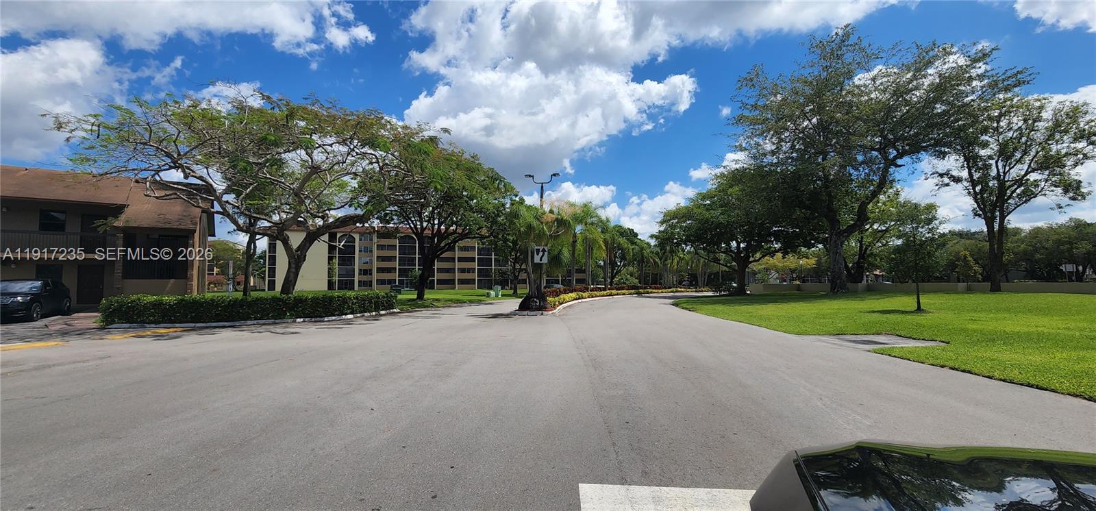 10029 Winding Lake Road, Unit 201 Sunrise, FL 33351 - Photo 22 of 22 a view of a house with a big yard and large trees