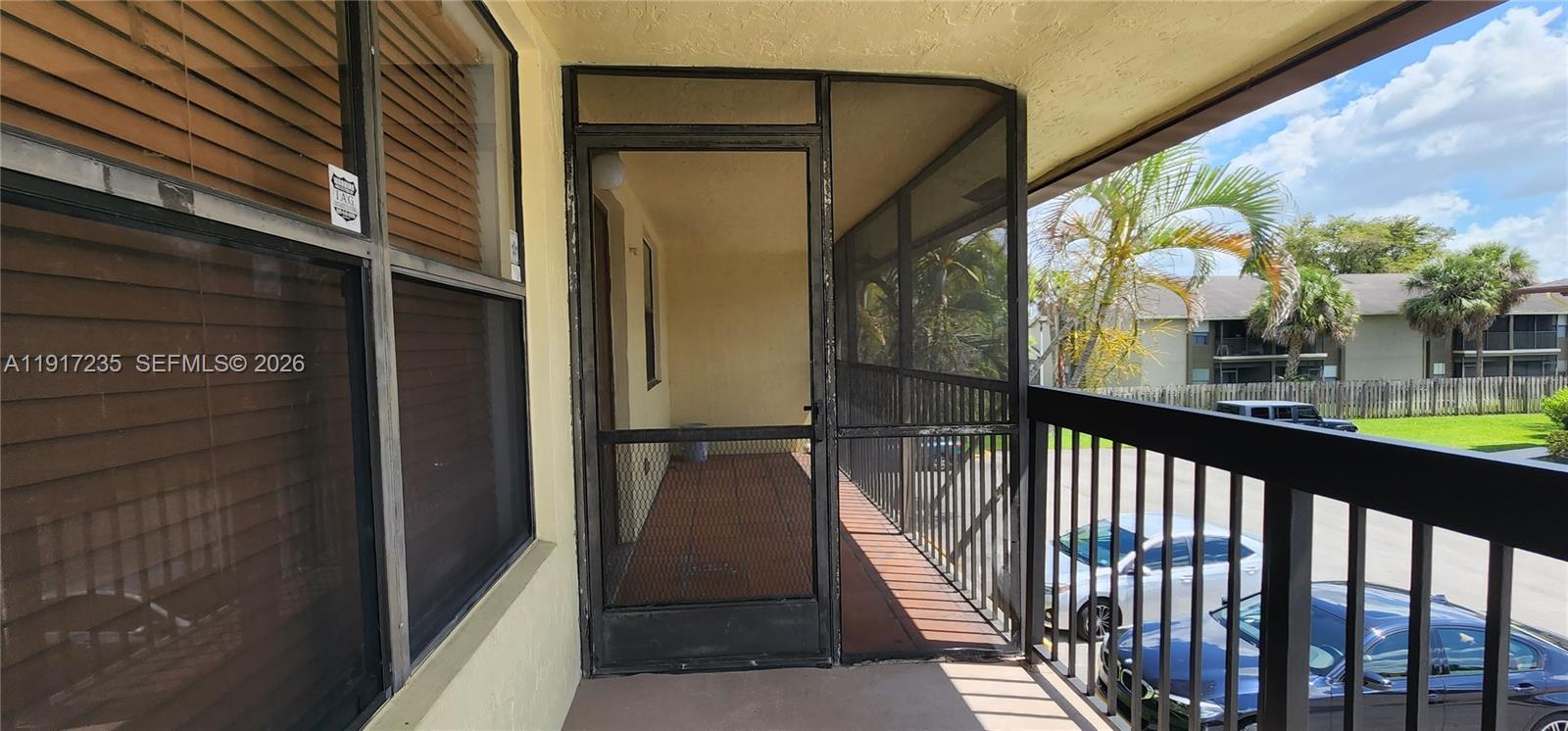10029 Winding Lake Road, Unit 201 Sunrise, FL 33351 - Photo 3 of 22 a view of a balcony with wooden floor