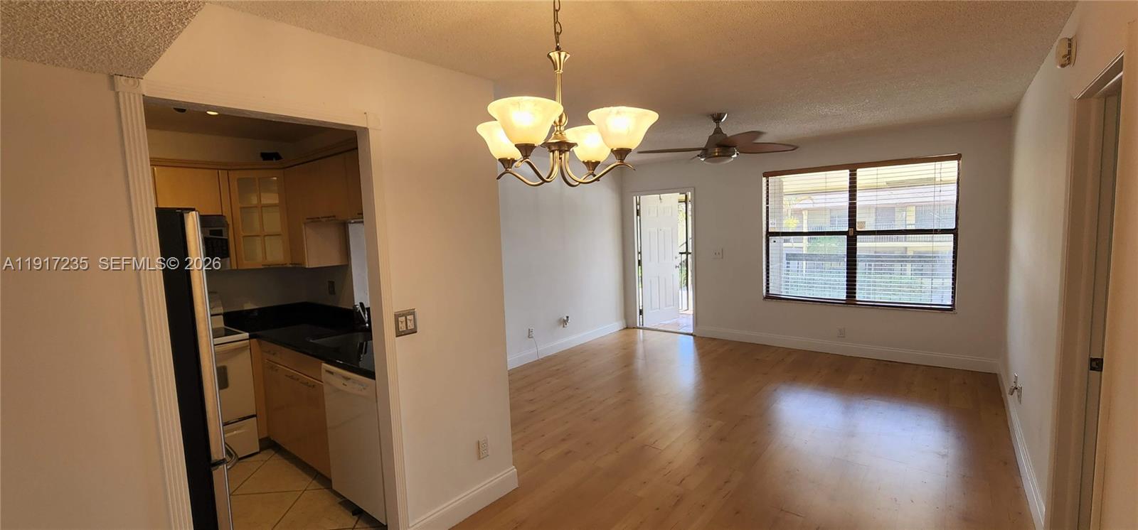 10029 Winding Lake Road, Unit 201 Sunrise, FL 33351 - Photo 5 of 22 a view of a hallway with wooden floor and a window