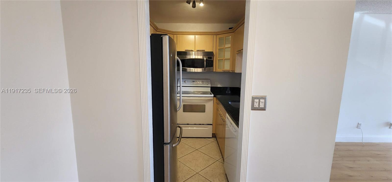 10029 Winding Lake Road, Unit 201 Sunrise, FL 33351 - Photo 6 of 22 a view of a kitchen from the hallway