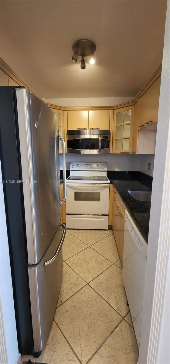 10029 Winding Lake Road, Unit 201 Sunrise, FL 33351 - Photo 7 of 22 a kitchen with stainless steel appliances a refrigerator and a stove