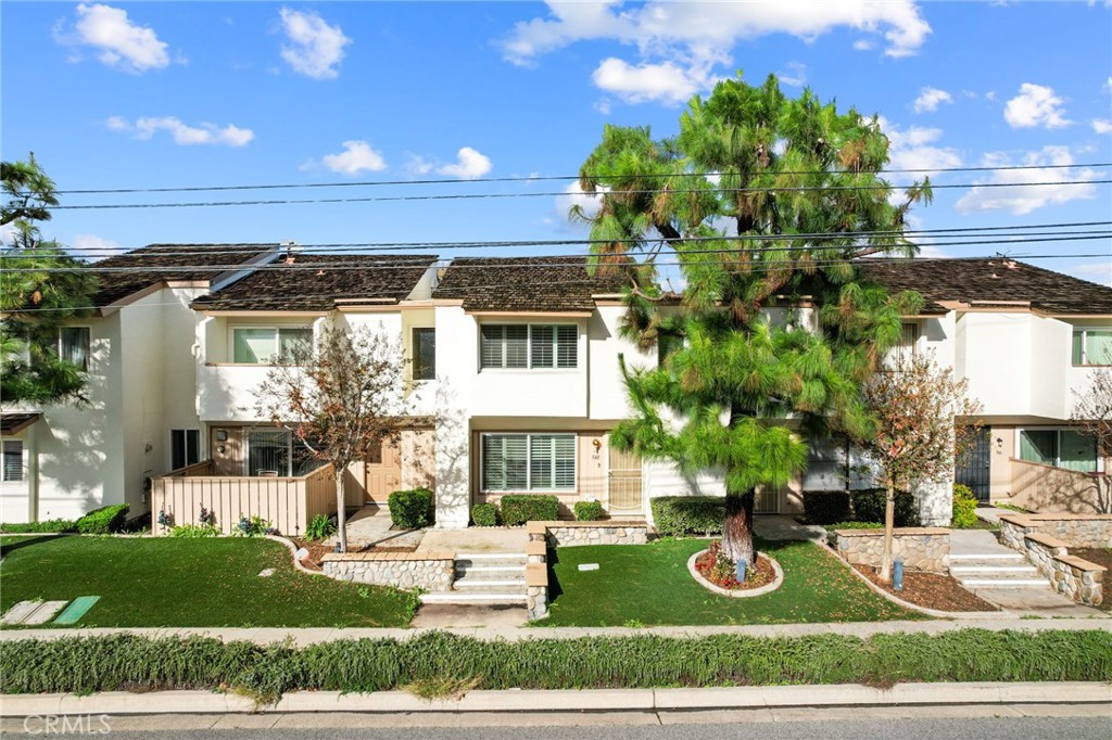 a view of a house with backyard sitting area and garden