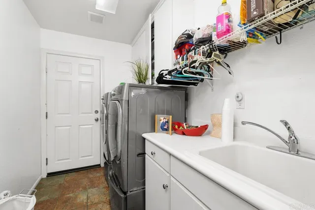 a kitchen with a refrigerator and a sink