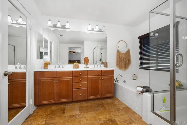 a spacious bathroom with a sink mirror and a bathtub