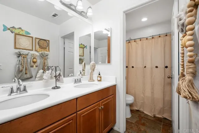 a bathroom with a double vanity sink mirror and double