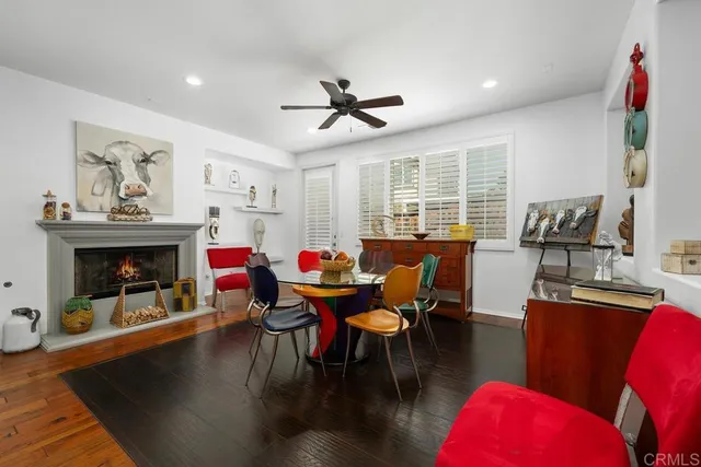 a dining room with furniture window and wooden floor