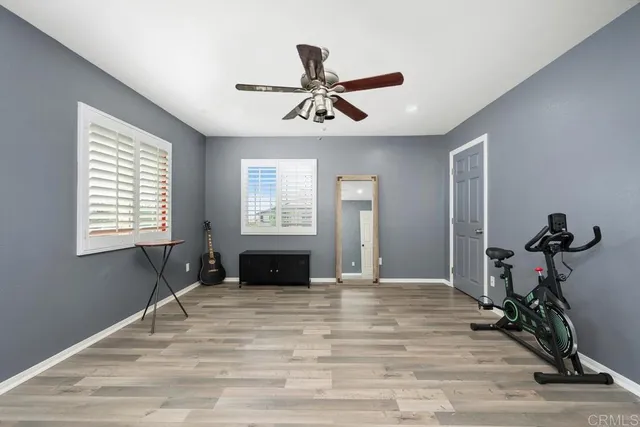 a view of empty room with a ceiling fan and window
