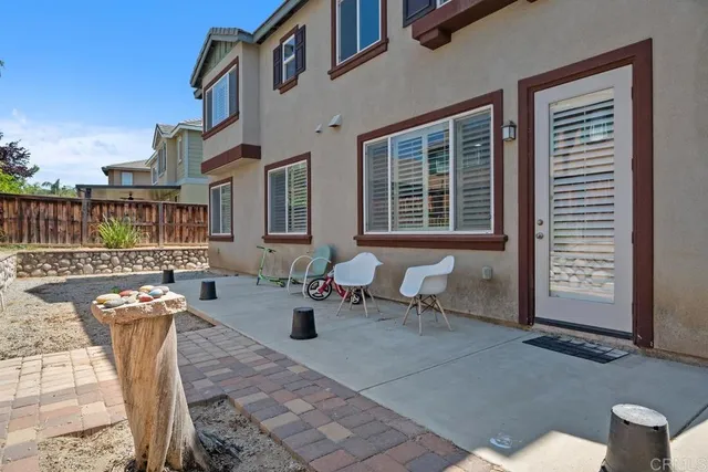 a view of a patio with couches table and chairs and potted plants