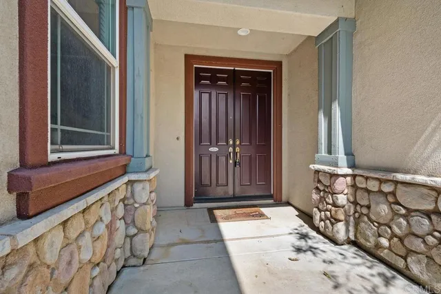 a view of front door with wooden door