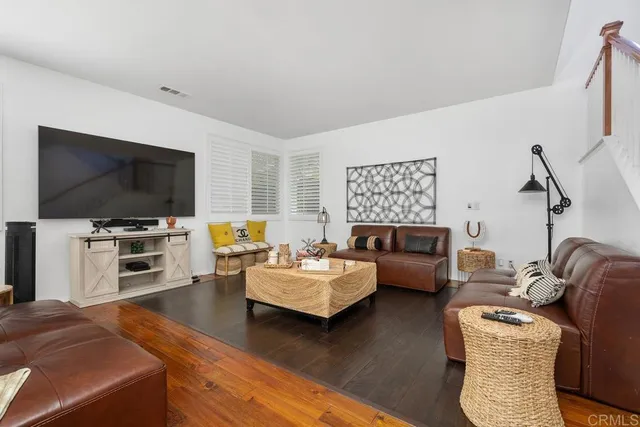a bedroom with furniture and a flat screen tv