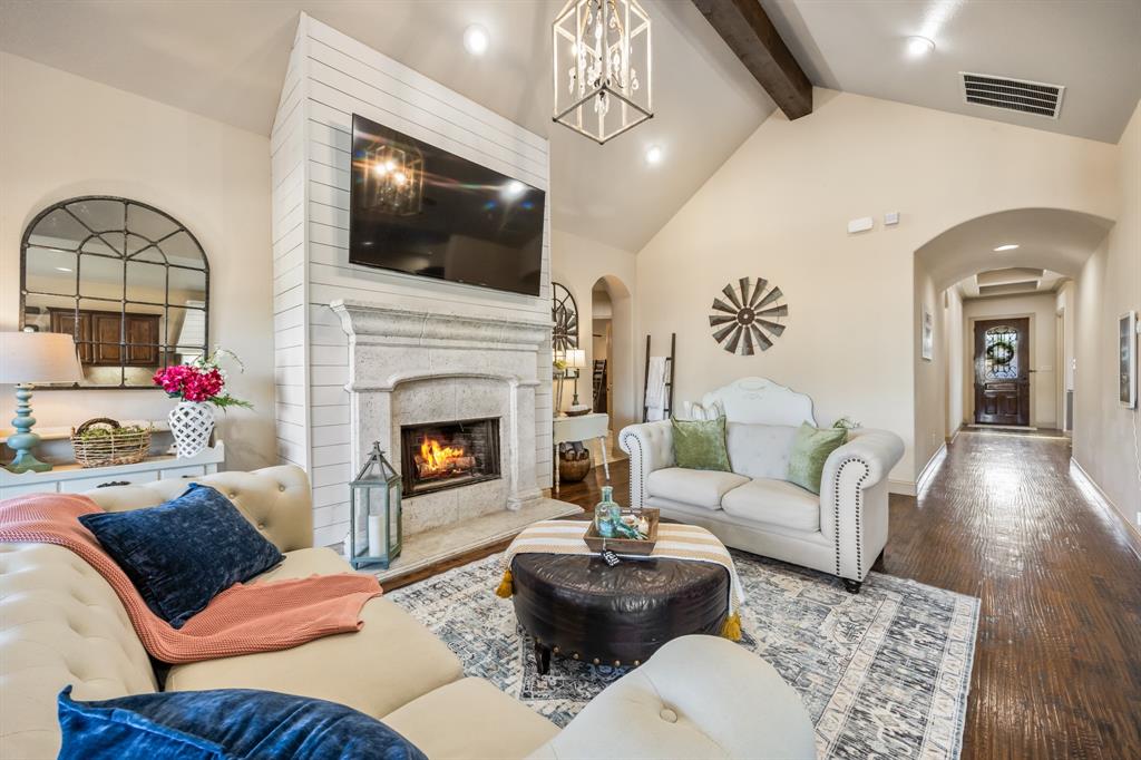 1206 Wedgewood Drive Forney, TX 75126 - Photo 14 of 40 a living room with furniture a flat screen tv and a fireplace
