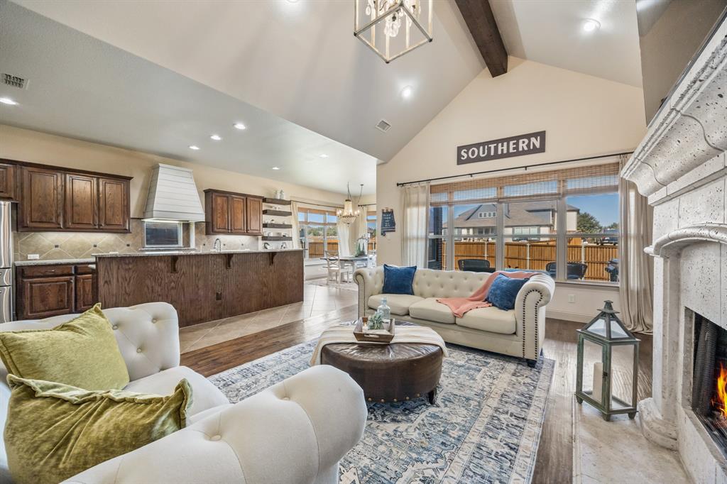 1206 Wedgewood Drive Forney, TX 75126 - Photo 16 of 40 a living room with furniture wooden floor and a view of kitchen