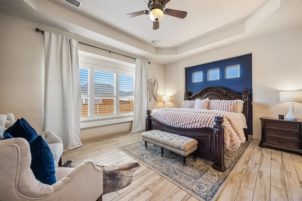 1206 Wedgewood Drive Forney, TX 75126 - Photo 22 of 40 a bedroom with a bed and wooden floor