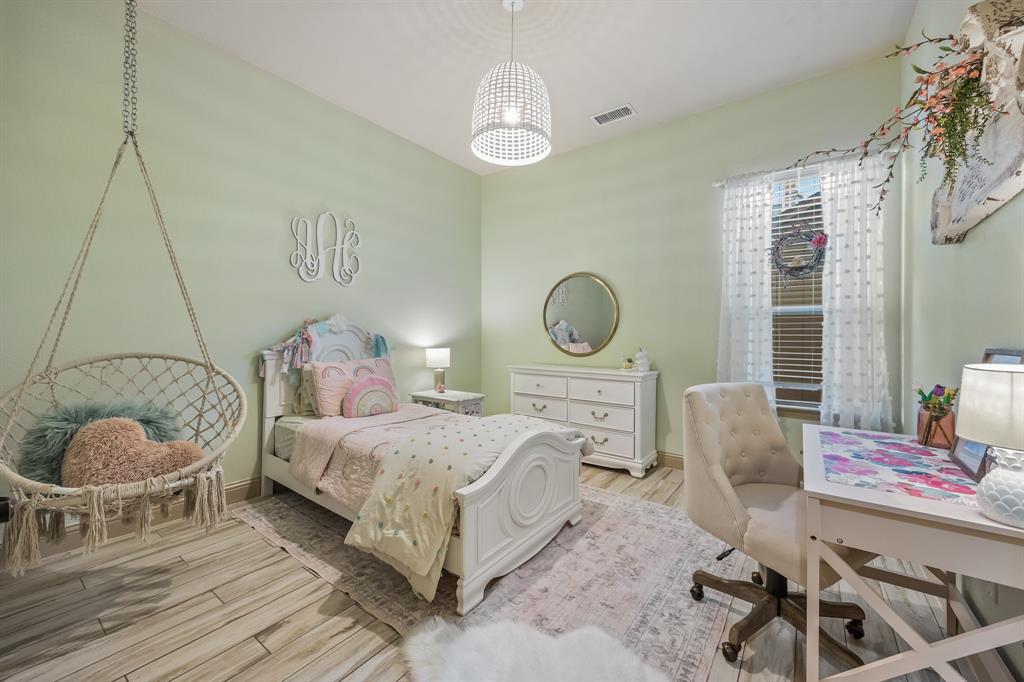 1206 Wedgewood Drive Forney, TX 75126 - Photo 27 of 40 a bedroom with a bed and window