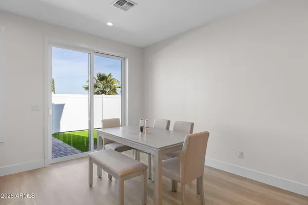 a view of a dining room with furniture and a potted plant