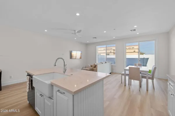a view of a kitchen area with furniture and wooden floor