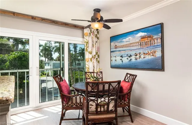 a view of a dining room with furniture wooden floor and a chandelier