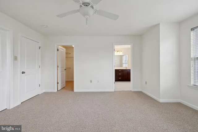 an empty room with a empty space and a ceiling fan