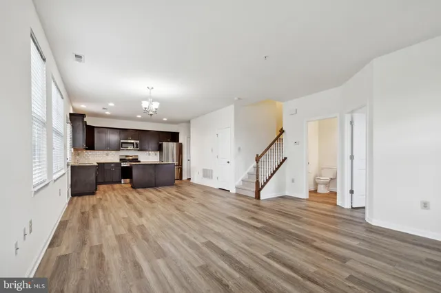 a view of a kitchen with furniture and wooden floor