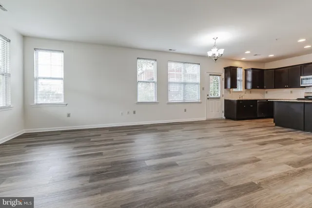 an empty room with wooden floor and window