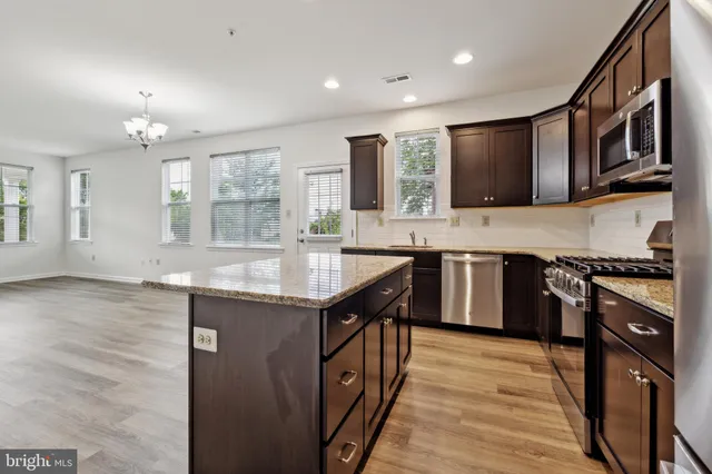 a kitchen with stainless steel appliances granite countertop a stove and a sink