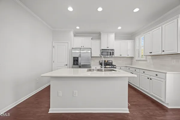 a kitchen with sink cabinets and wooden floor