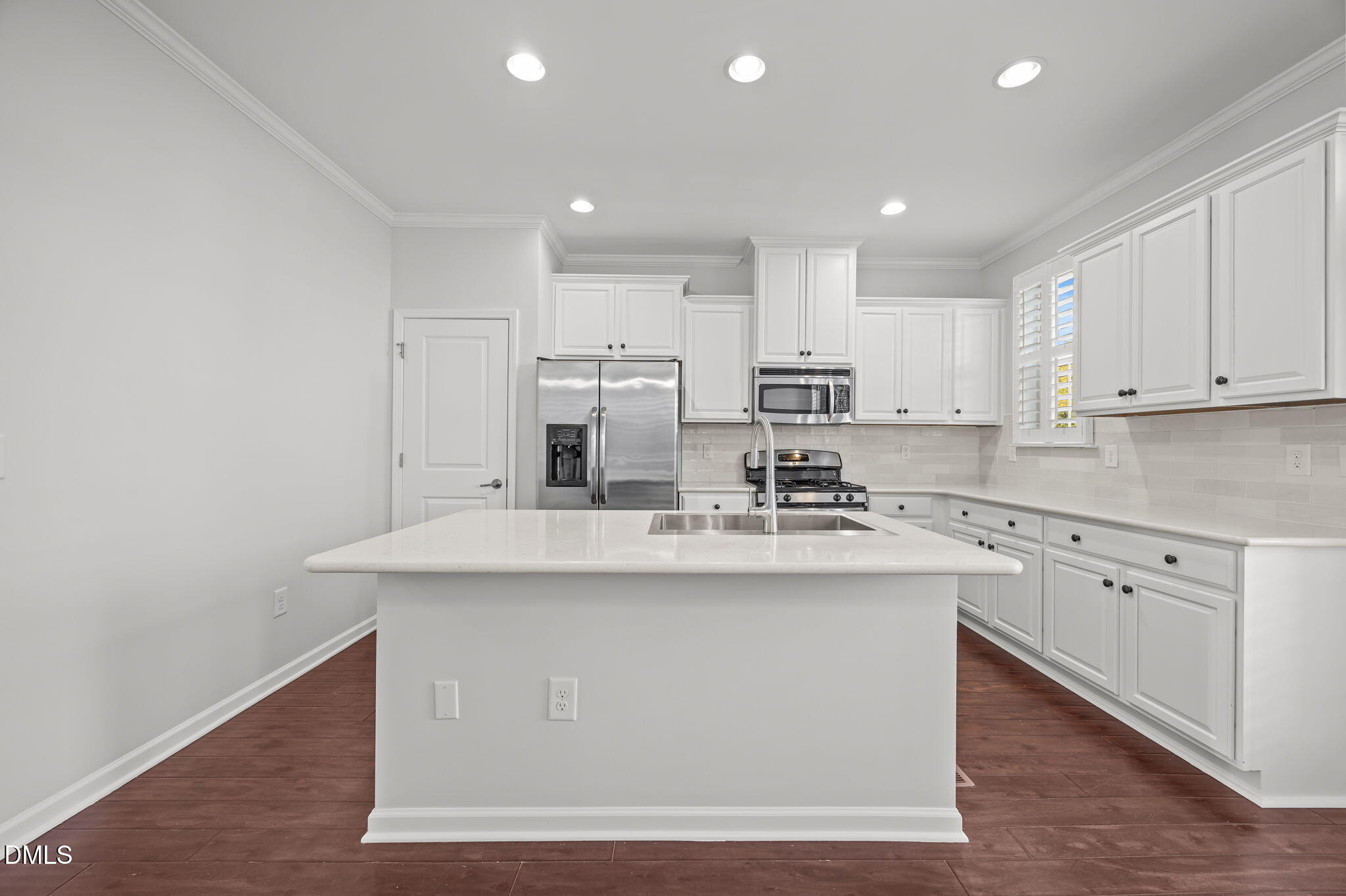 1319 Rodessa Run Raleigh, NC 27607 - Photo 10 of 64 a kitchen with stainless steel appliances granite countertop a sink a stove and white cabinets