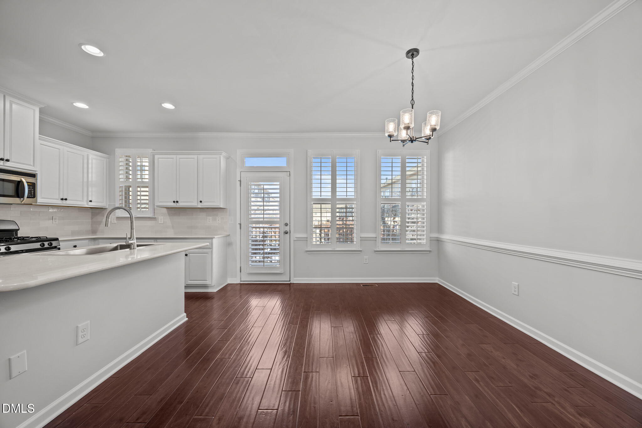 1319 Rodessa Run Raleigh, NC 27607 - Photo 14 of 64 a kitchen with stainless steel appliances a refrigerator sink and wooden floor