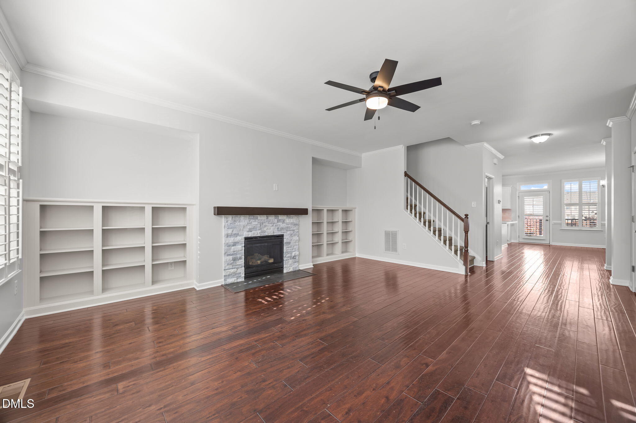 1319 Rodessa Run Raleigh, NC 27607 - Photo 18 of 64 a view of a livingroom with wooden floor a fireplace and windows