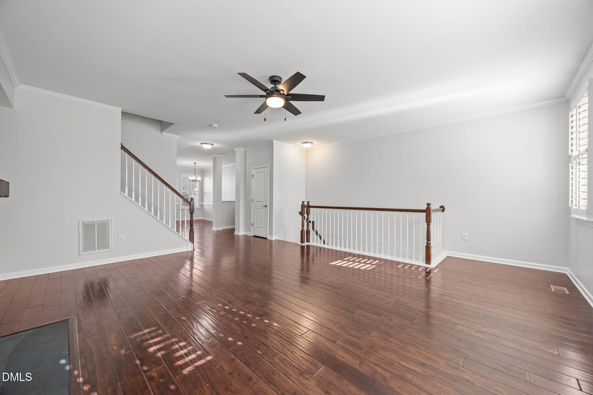 1319 Rodessa Run Raleigh, NC 27607 - Photo 19 of 64 a view of an empty room with wooden floor and a ceiling fan