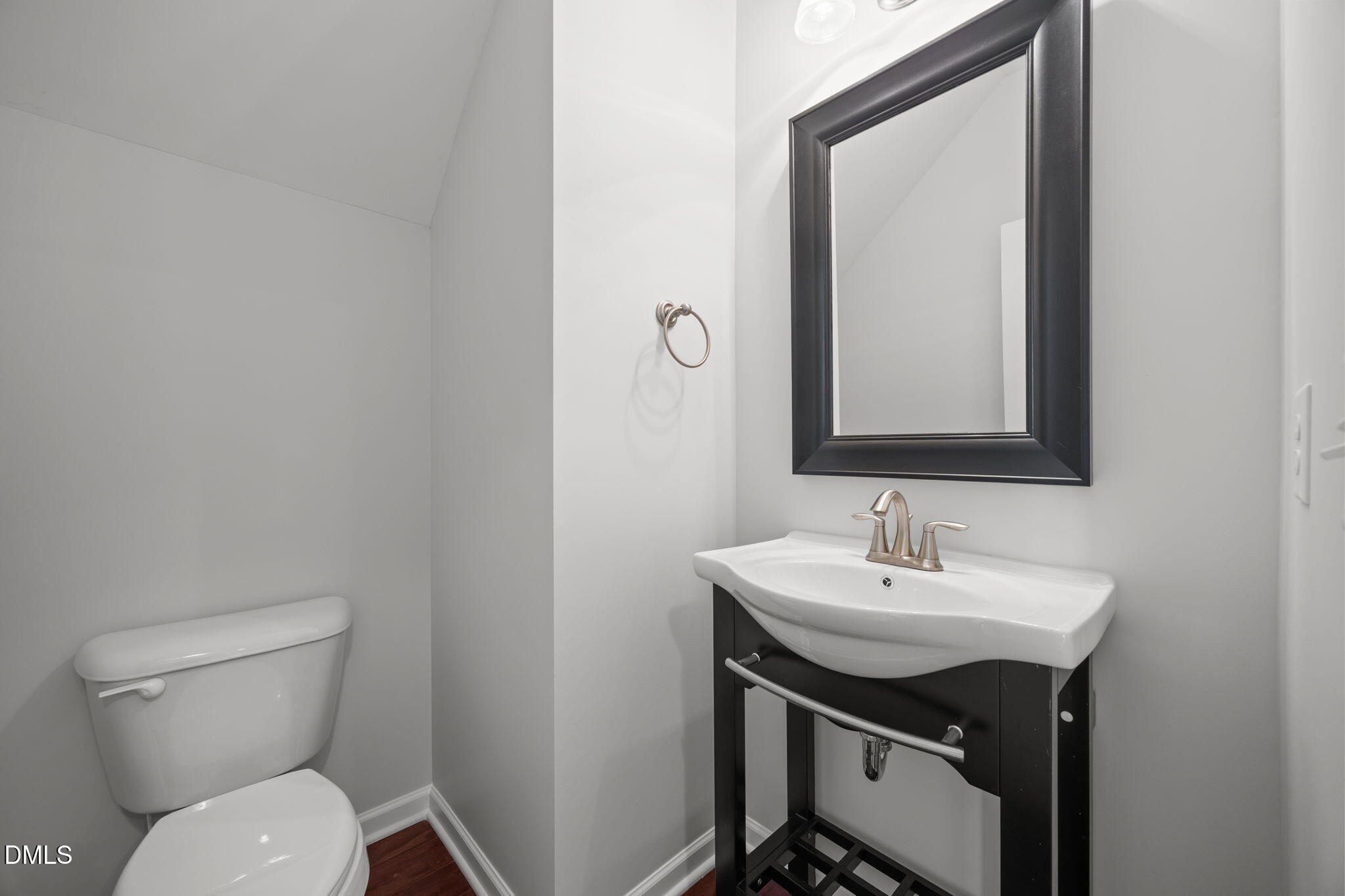 1319 Rodessa Run Raleigh, NC 27607 - Photo 21 of 64 a bathroom with a toilet a sink and mirror