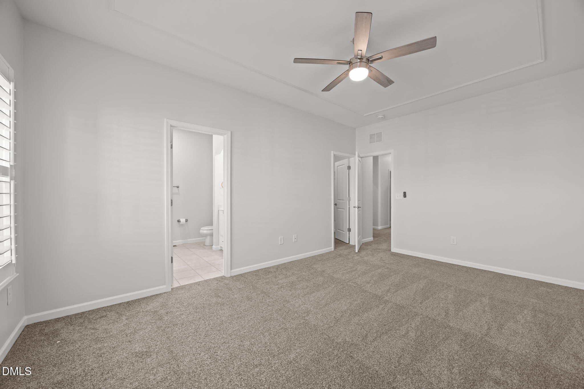 1319 Rodessa Run Raleigh, NC 27607 - Photo 25 of 64 an empty room with a ceiling fan and a window