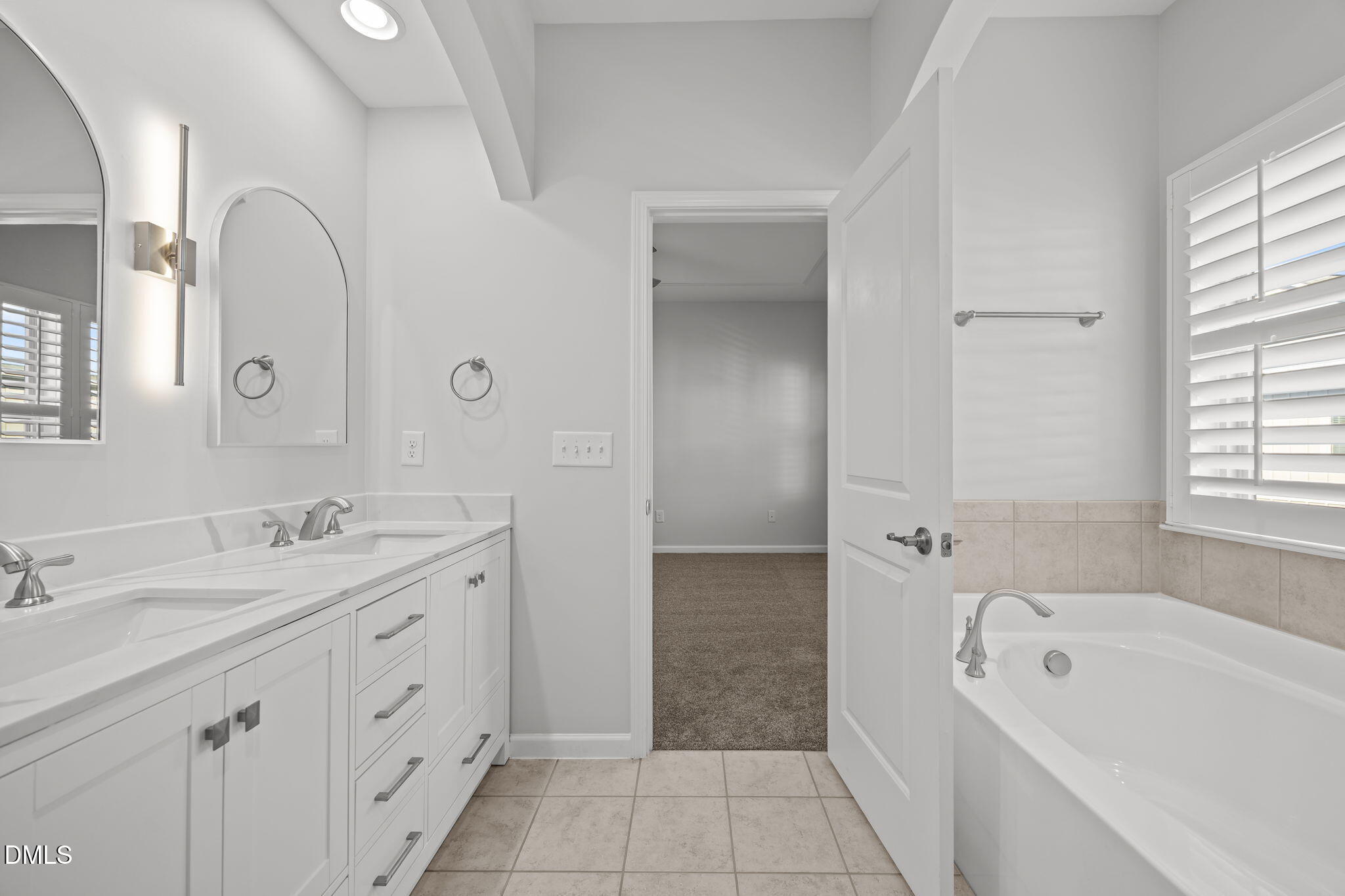 1319 Rodessa Run Raleigh, NC 27607 - Photo 29 of 64 a bathroom with a tub a sink and a mirror