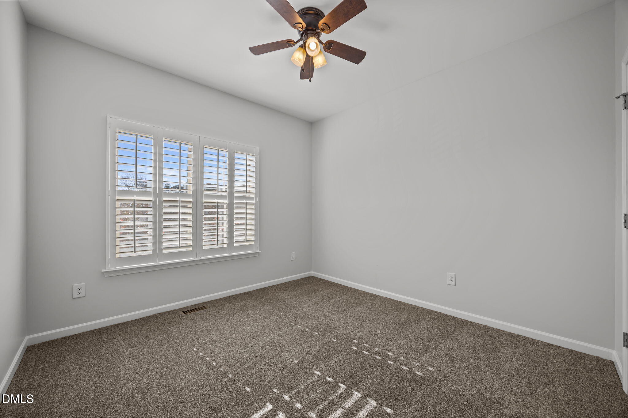 1319 Rodessa Run Raleigh, NC 27607 - Photo 33 of 64 an empty room with a window and a fan