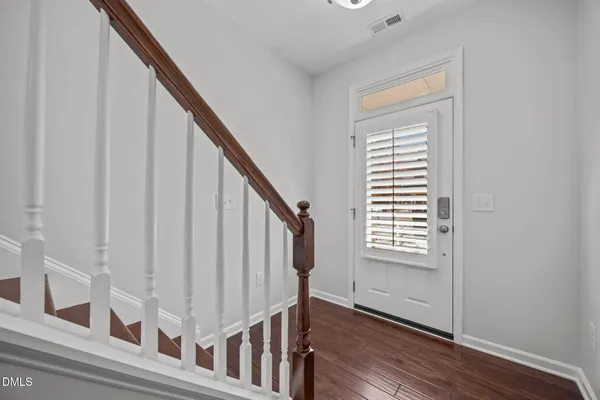 a view of an empty room with wooden floor