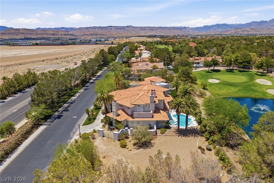 20 Innisbrook Avenue Las Vegas, NV 89113 - Photo 10 of 39 Perched on a desert landscape, this luxurious estate boasts a shimmering pool and picturesque golf course views.
