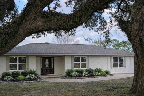 a front view of a house with a garden