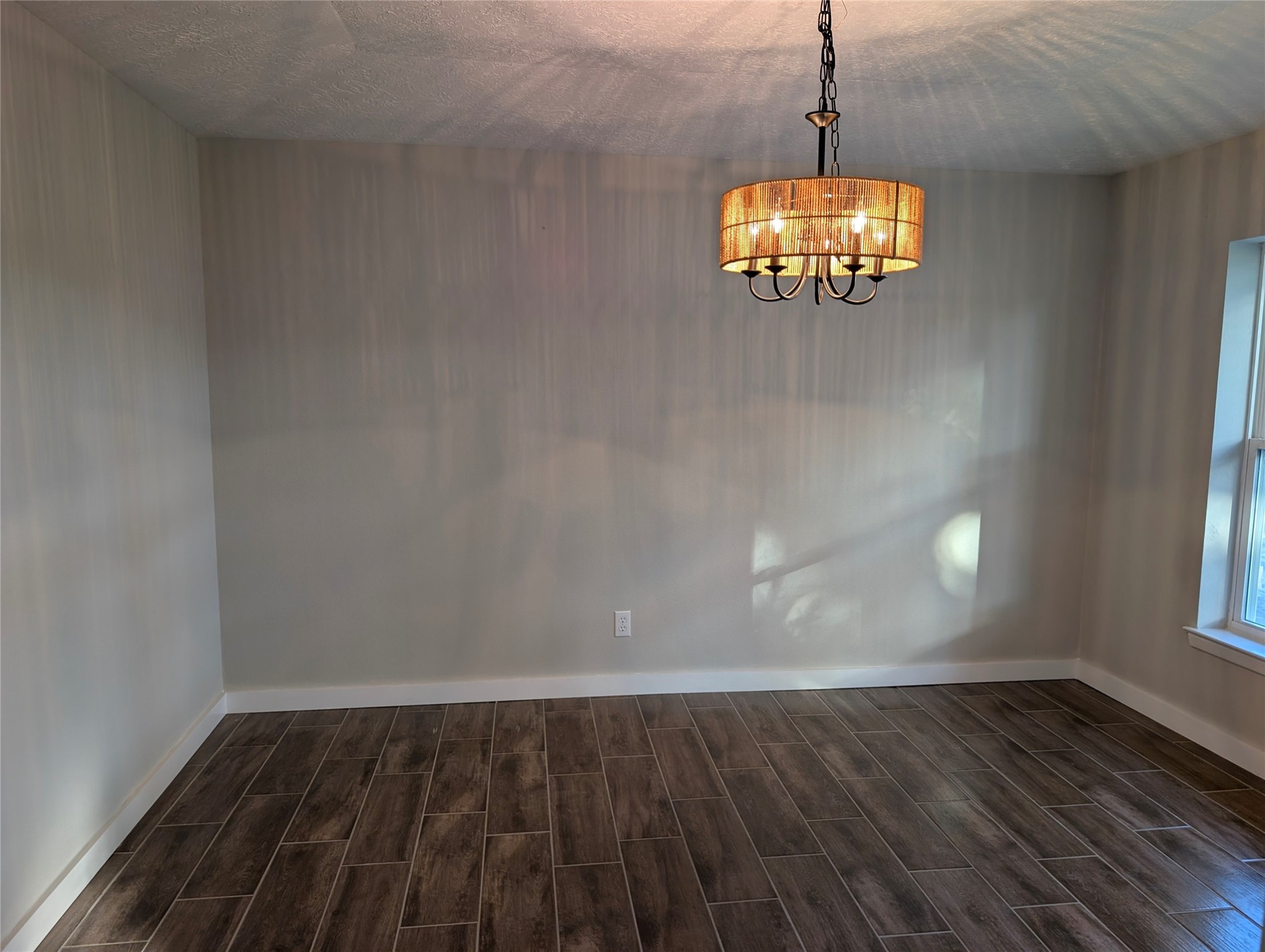 1145 Cuniff Road Sour Lake, TX 77659 - Photo 12 of 22 a view of a room with wooden floor and windows