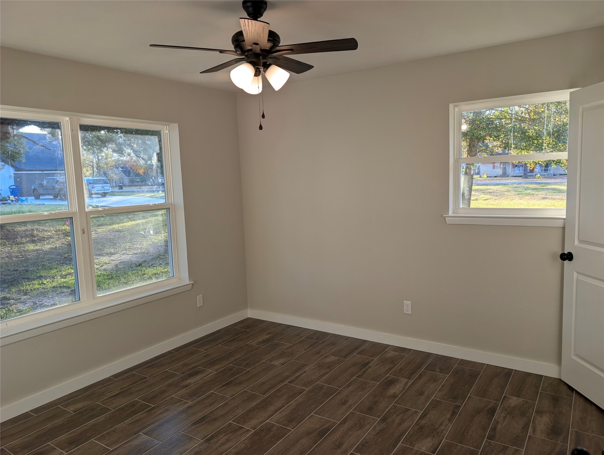 1145 Cuniff Road Sour Lake, TX 77659 - Photo 13 of 22 an empty room with wooden floor and windows