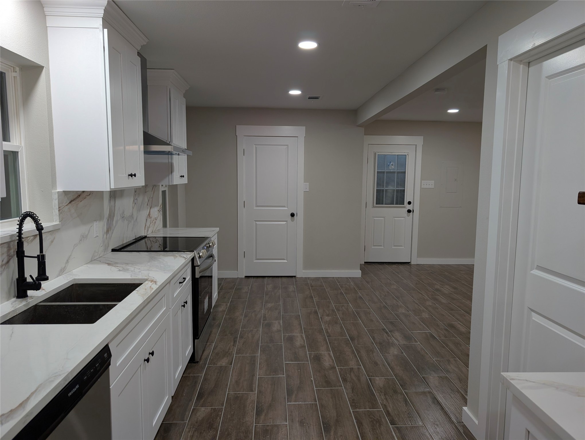 1145 Cuniff Road Sour Lake, TX 77659 - Photo 4 of 22 a kitchen with a sink stove and cabinets