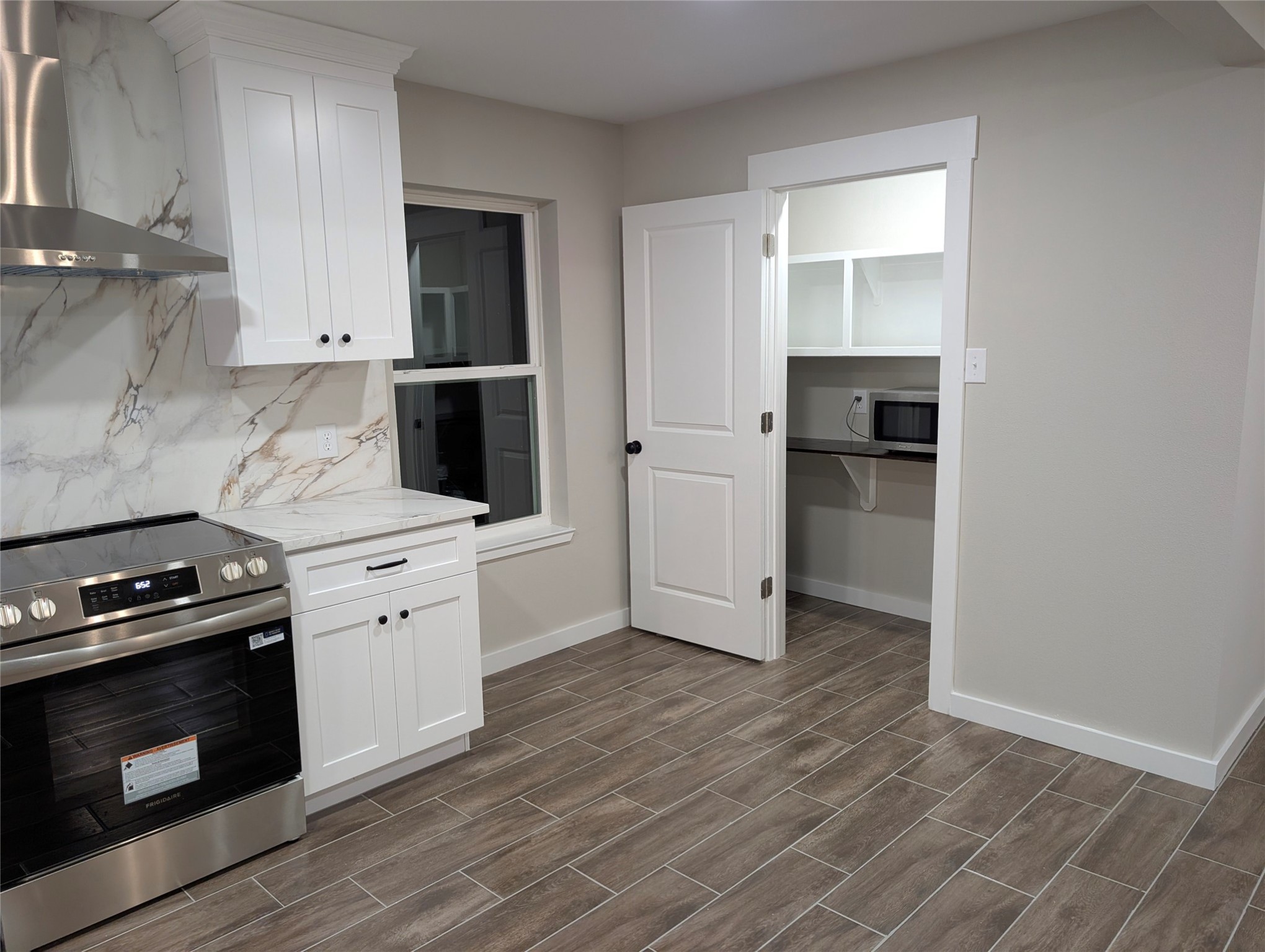 1145 Cuniff Road Sour Lake, TX 77659 - Photo 6 of 22 a kitchen with granite countertop a stove and a sink