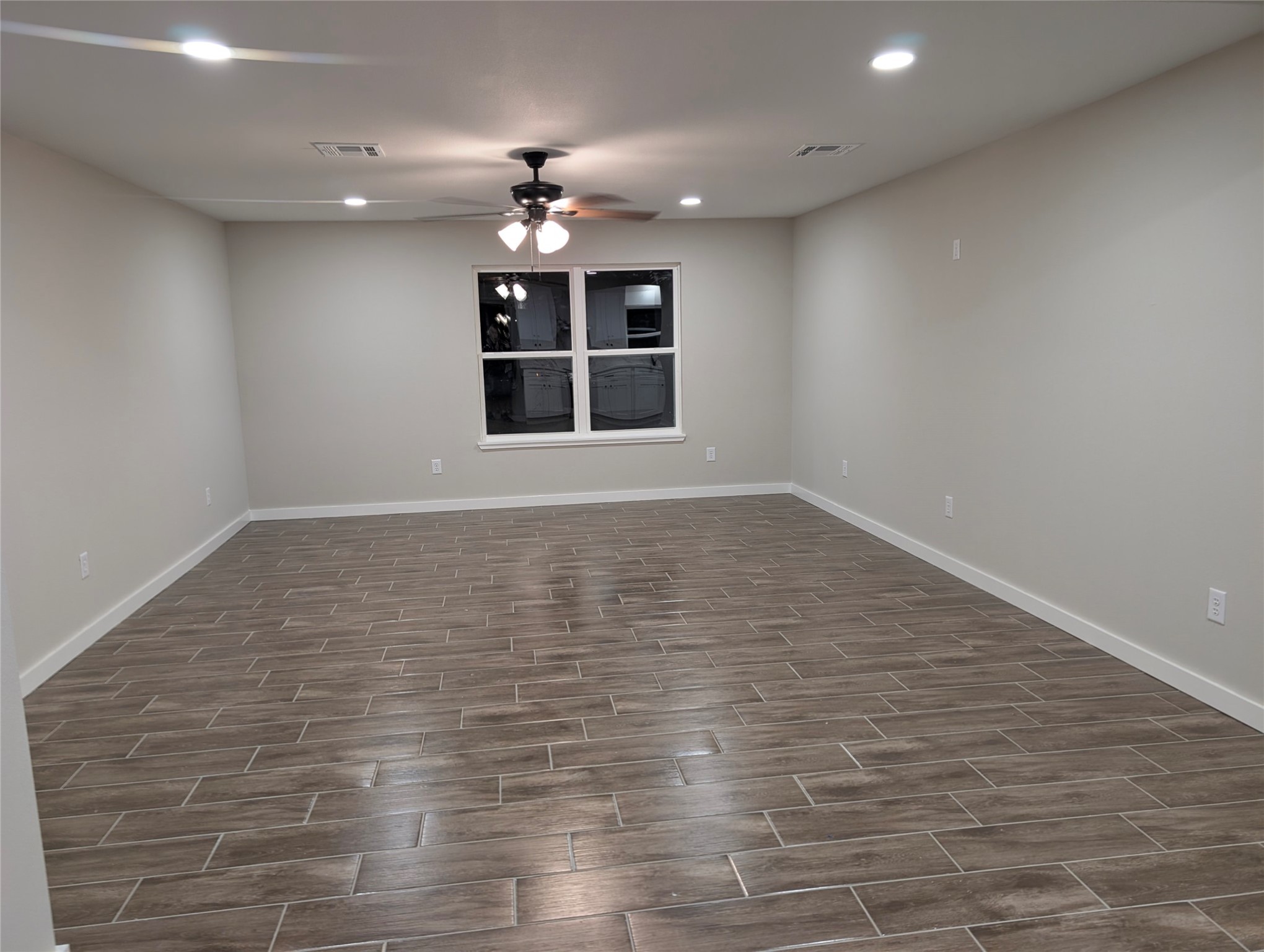 1145 Cuniff Road Sour Lake, TX 77659 - Photo 7 of 22 an empty room with wooden floor and chandelier