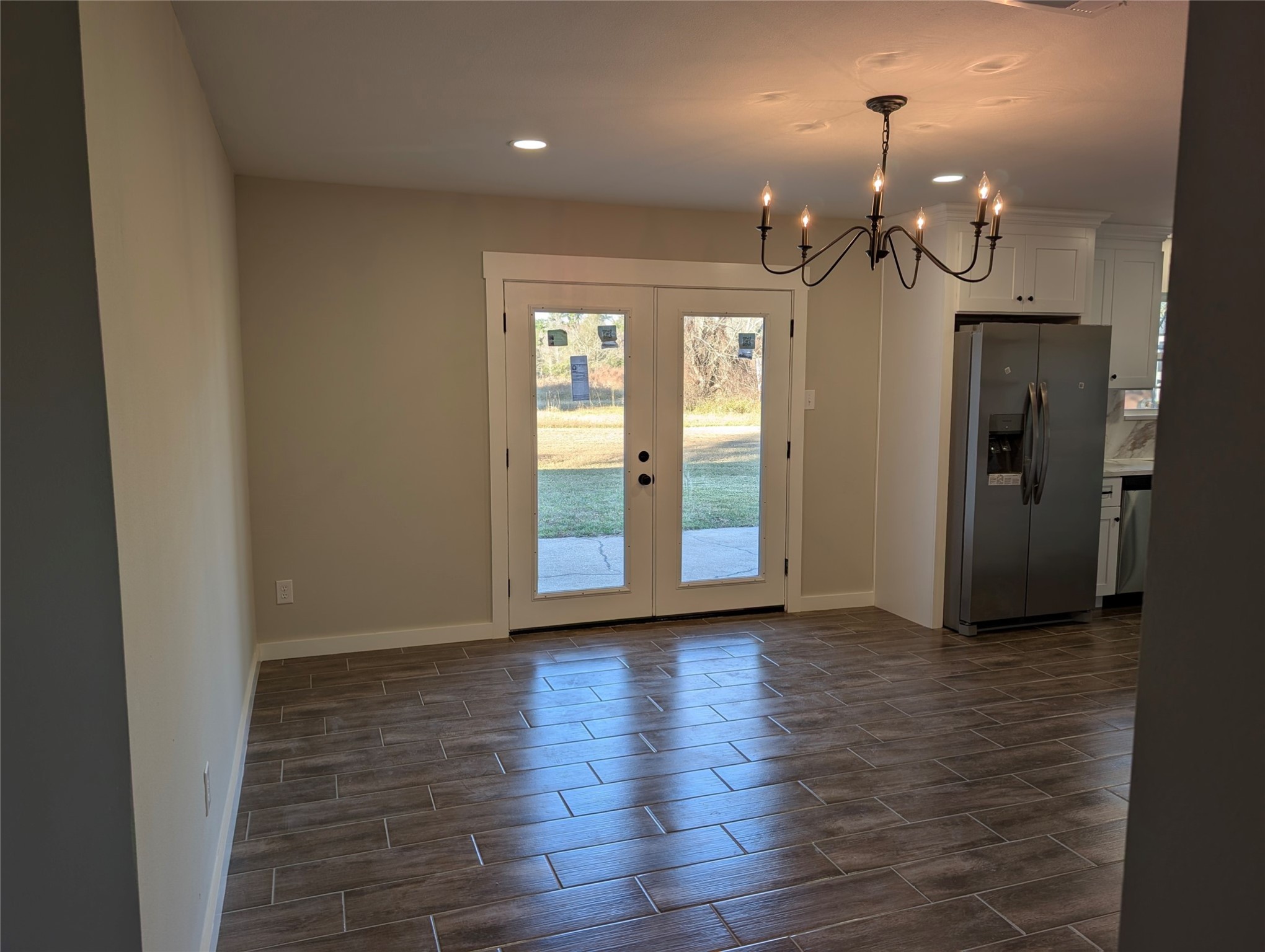 1145 Cuniff Road Sour Lake, TX 77659 - Photo 9 of 22 an empty room with wooden floor and windows