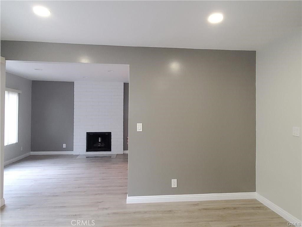 423 East Duarte Road, Unit A Arcadia, CA 91006 - Photo 3 of 11 an empty room with wooden floor and windows